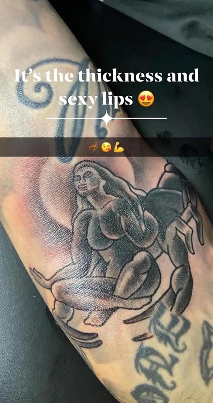 Close-up of a poorly executed tattoo design on an arm with text overlay.