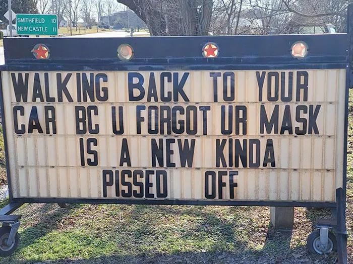 Funny sign about forgetting a mask, displayed outdoors with a humorous message to entertain and engage viewers.