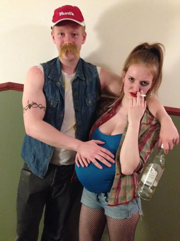 Couple in simple Halloween costumes with a fake pregnancy belly and casual clothes, showing great results with minimal effort.