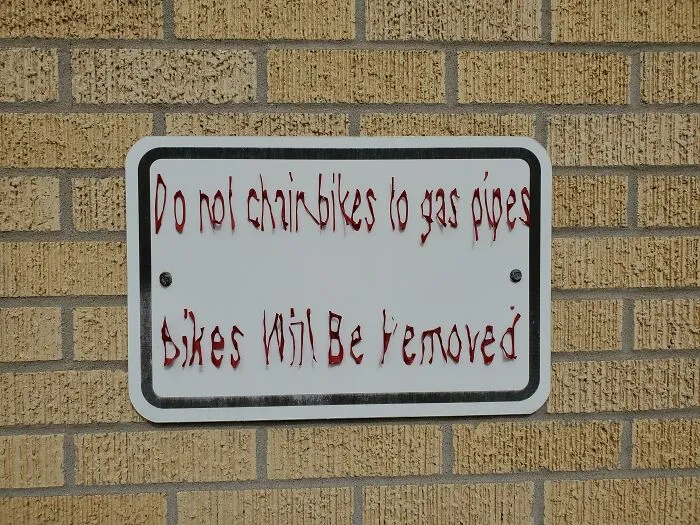 This Sun-Worn Sign Outside My Office That Looks Like It Belongs In A Horror Film