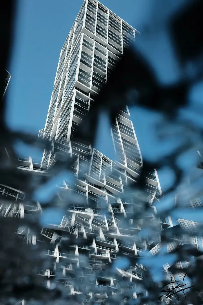 Picture Of Building As Reflected In Broken Mirror On Pavement