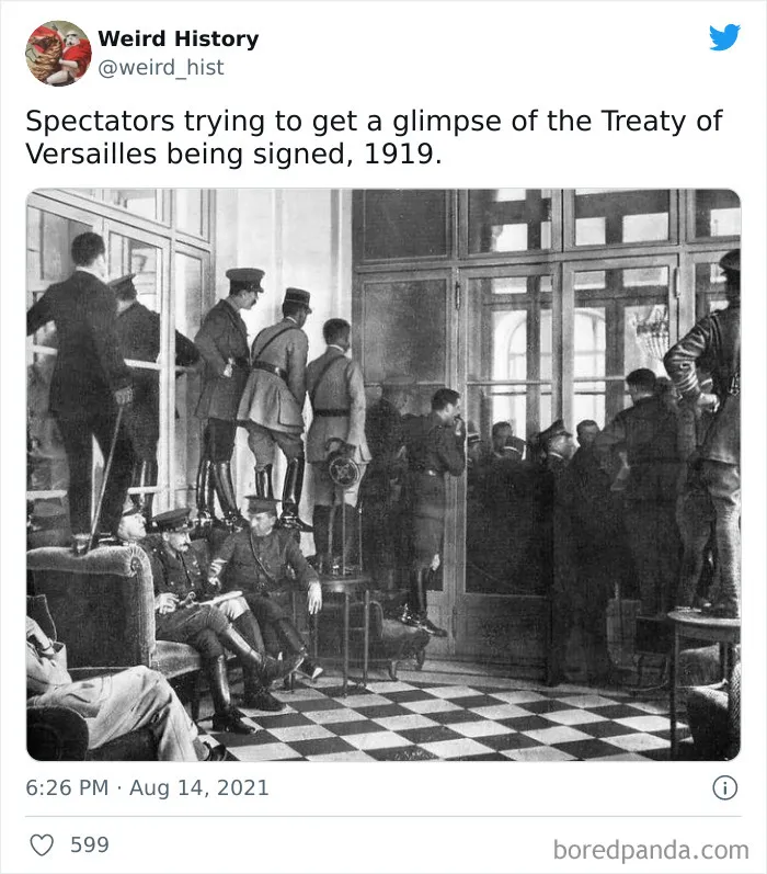 Spectators in military uniforms trying to glimpse the Treaty of Versailles signing in 1919, a weird history moment.