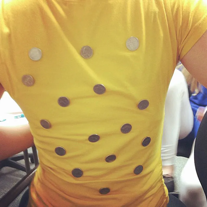 Person wearing a simple yellow shirt with coins attached as a creative Halloween costume idea that turned out great.