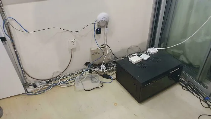 The Server / WiFi Setup Where I Work. (The Tupperware Is To Catch The Water From The Leaky Aircon)