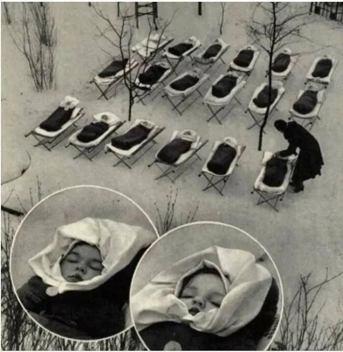 "Important historical photo of babies in outdoor cribs during snowy conditions, highlighting unconventional childcare practices."