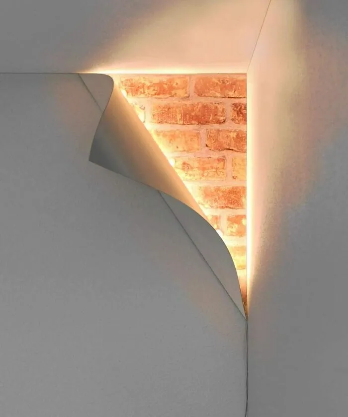 Esta luz de esquina hace que parezca que la pared se desprende y revela algo detrás de ella