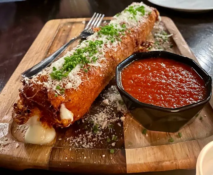 Comically Oversized Mozzarella Stick With Tub Of Marinara