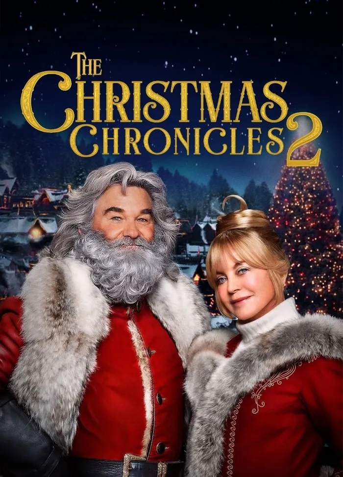 Cozy scene from the Christmas movie "The Christmas Chronicles 2" featuring festive holiday attire and a decorated tree.