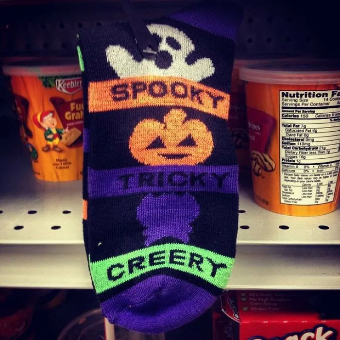 A pair of Halloween socks with the word creery printed instead of creepy, showing a fail
