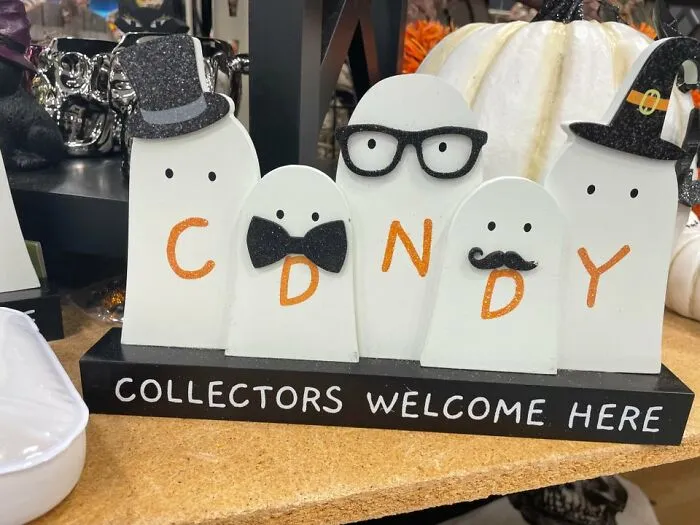 Spooky decor featuring ghosts that misspell candy as CDNDY, a funny Halloween fail