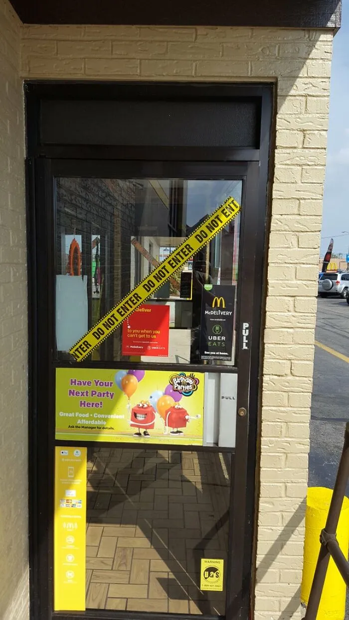 A restaurant door blocked by yellow caution tape as part of funny Halloween fails.
