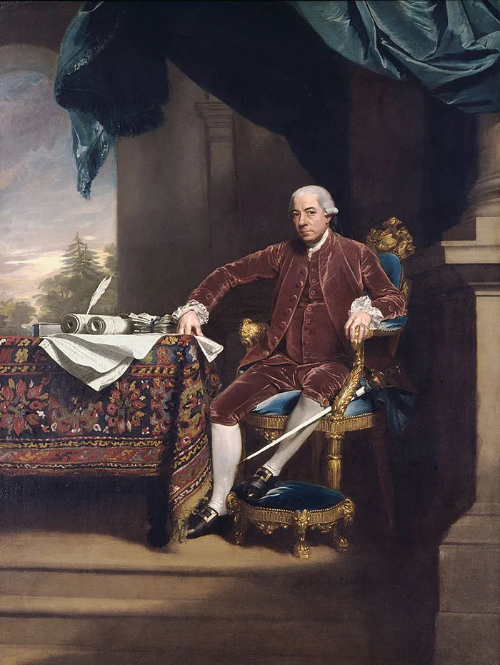 A man in historical attire seated by a table with intricate detail, showcasing one of the famous paintings in art history.