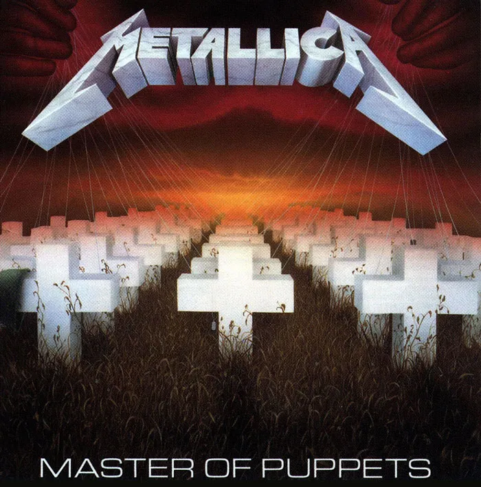 Metallica album cover featuring white crosses in a field, with hands controlling strings against a red sunset sky.