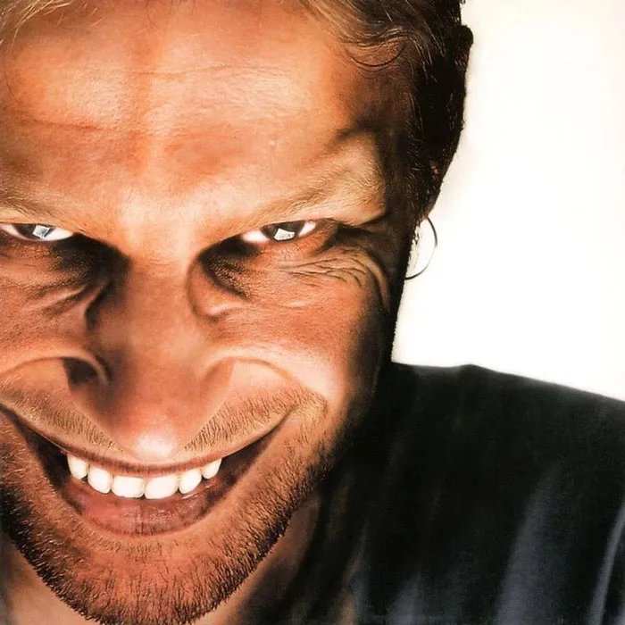 Close-up of a grinning face on a famous album cover, showcasing artistic expression.