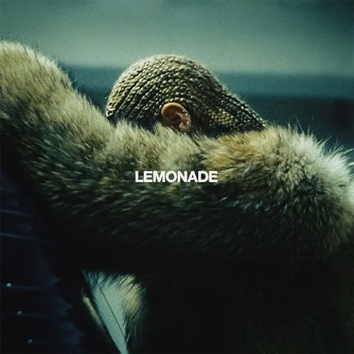 Fur coat and braided hair on an iconic album cover with bold "LEMONADE" text, showcasing one of the greatest album covers.