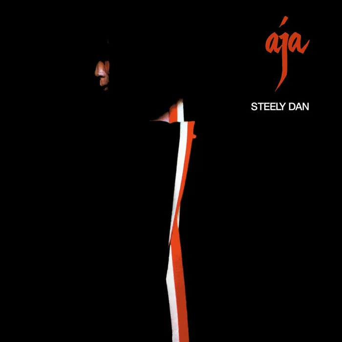 Steely Dan's "Aja" album cover with a minimalist black and red design.
