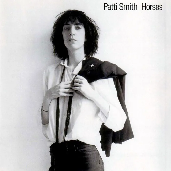 Iconic album cover featuring a person in a white shirt with a jacket over the shoulder, exemplifying greatest album covers.
