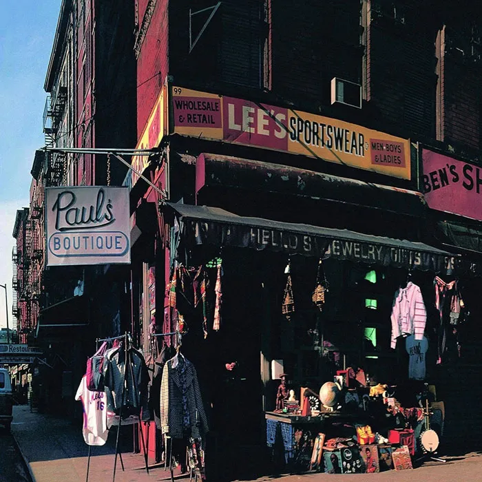 Greatest album cover featuring a street boutique with clothing and signage in an urban setting.