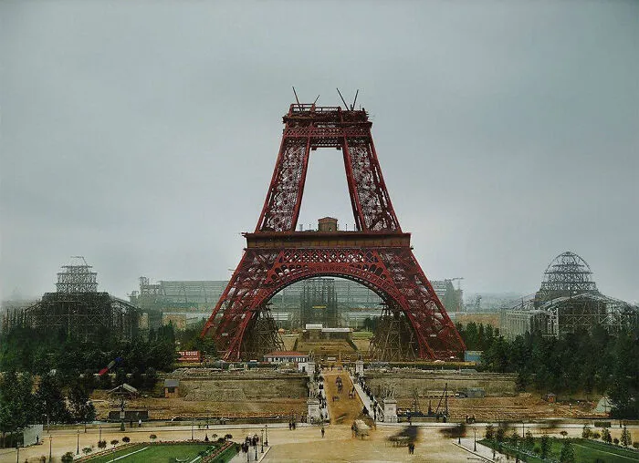 Eiffel Tower under construction, showcasing historical architecture in Paris amidst a vast construction site.