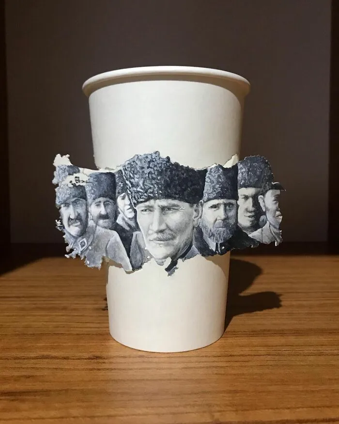 Paper cup with detailed illustrations of men in traditional hats drawn by an artist while traveling the world.