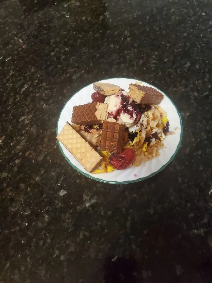 French Toast Souffle With Organic Blueberry Jam, And Vanilla Icecream With A Nutty Buddy And Some Berries On Top.