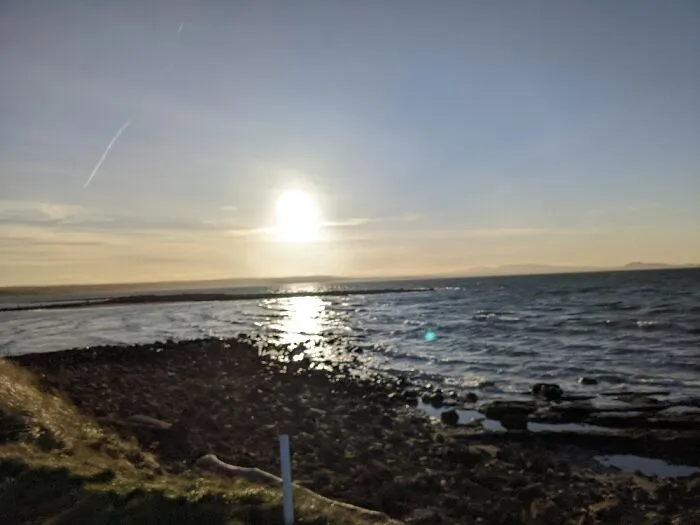 A Small Beach Next To A Golf Course In Scotland