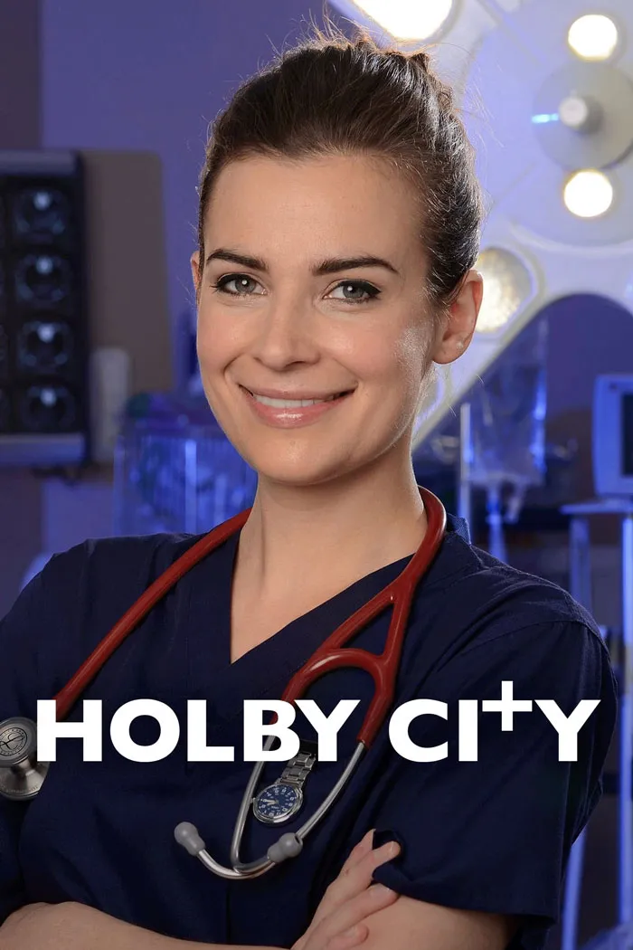 Female doctor from "Holby City" in a hospital setting, wearing scrubs and a stethoscope.