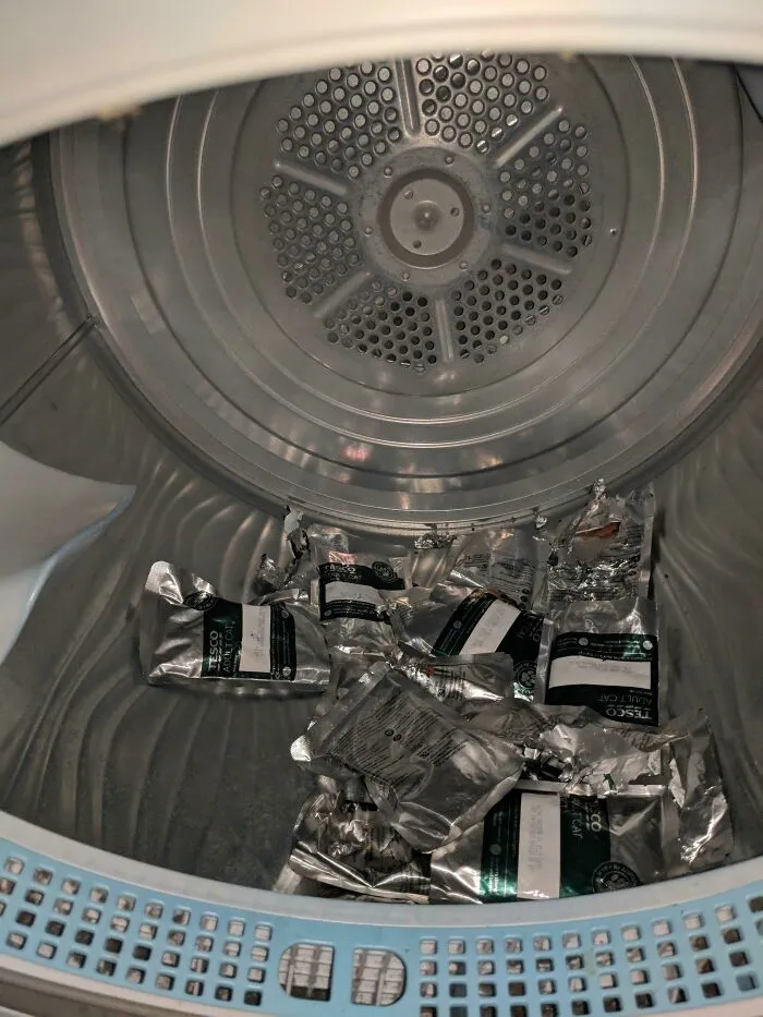 My Cat Got Into His Food Cupboard While I Was At Work, Stole All The Food Packets One By One, Then Hid Them In The Dryer 
