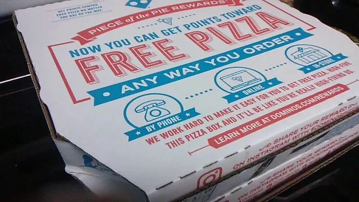 A Literal Used Domino's Pizza Box With Plastic Golf Balls Inside