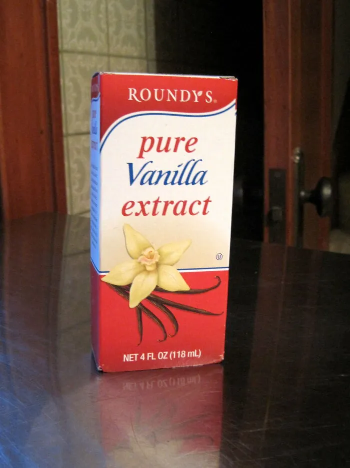 Pouring Vanilla Extract Into A Salad