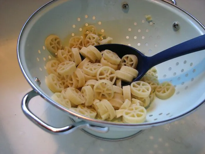 Using A Colander To Strain Linguine