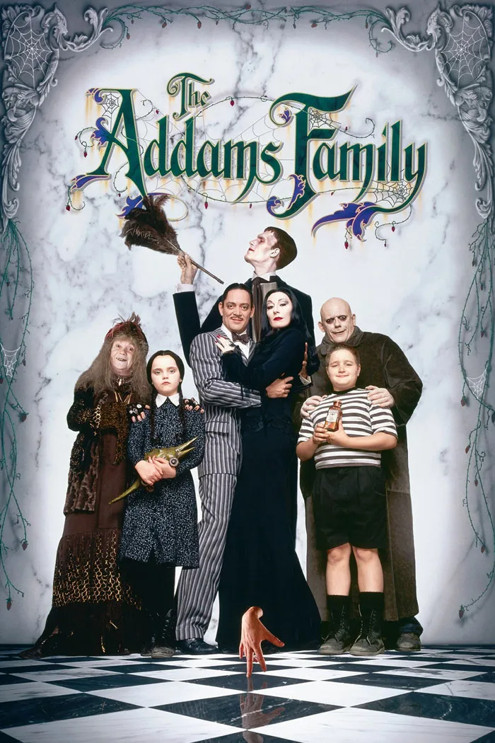 The Addams Family movie cast posing in gothic attire on a checkered floor, representing dark comedy movies.