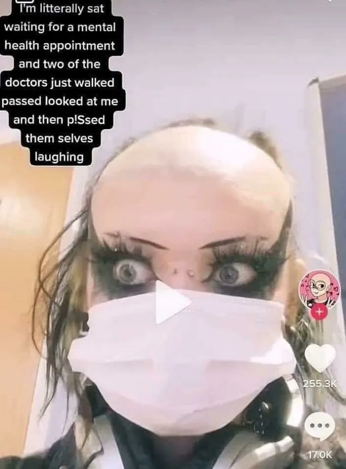 Close-up of a person with a unique hairstyle, wearing dramatic makeup and a mask, showcasing one of the worst hairstyles.
