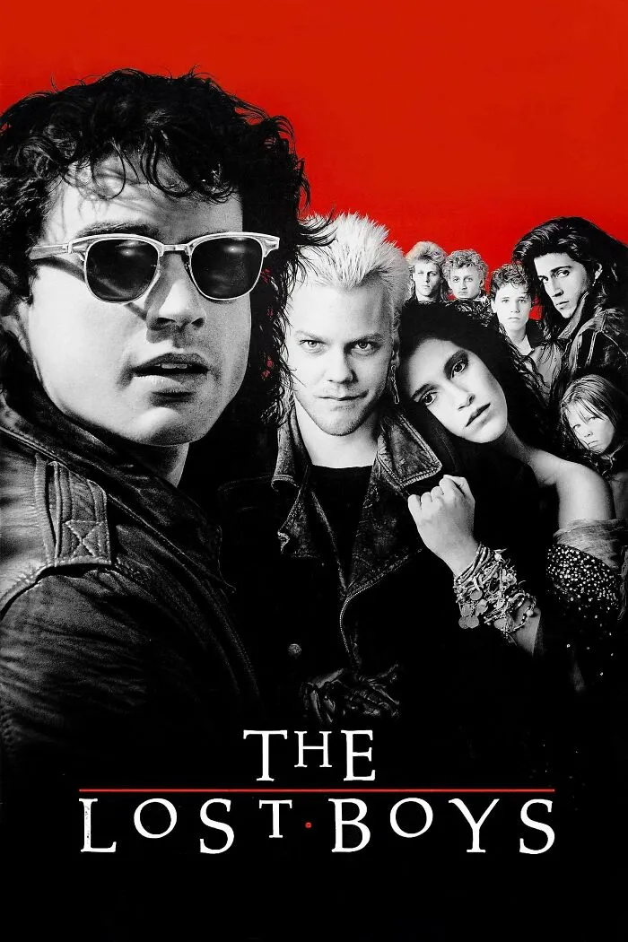 Group of young adults in dark clothing and leather jackets with intense expressions against a red background, horror comedy theme.
