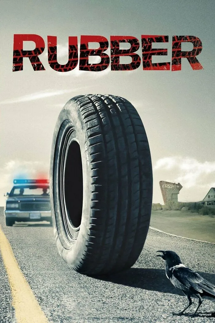Giant tire on a road with a police car and a crow in the background, representing horror comedies theme.