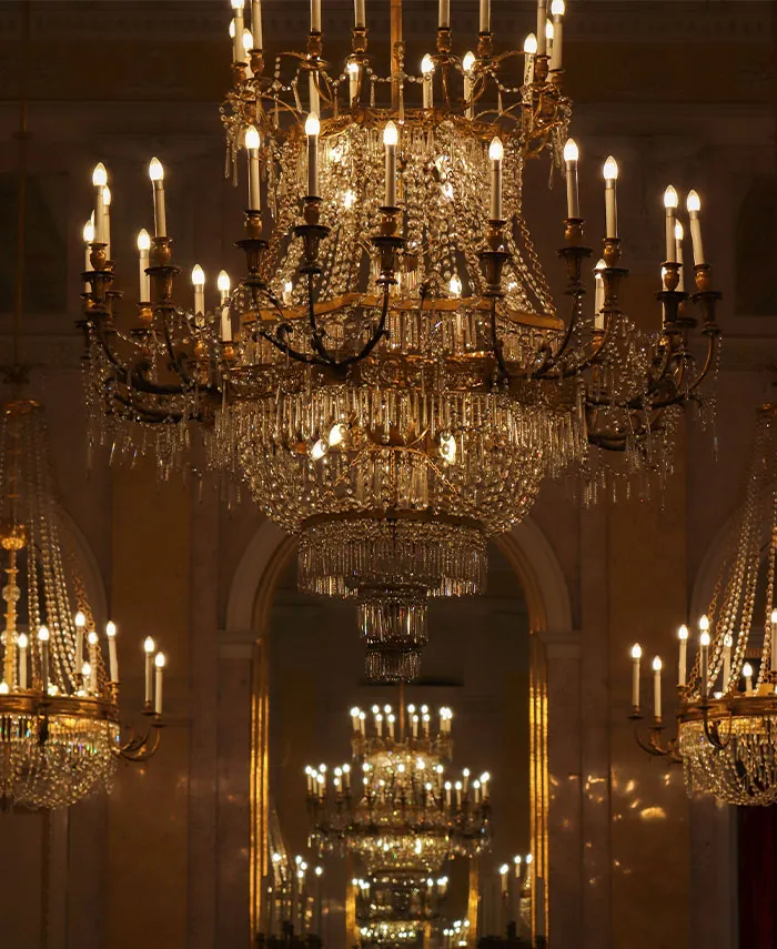 Massive lit up chandelier in a big room 