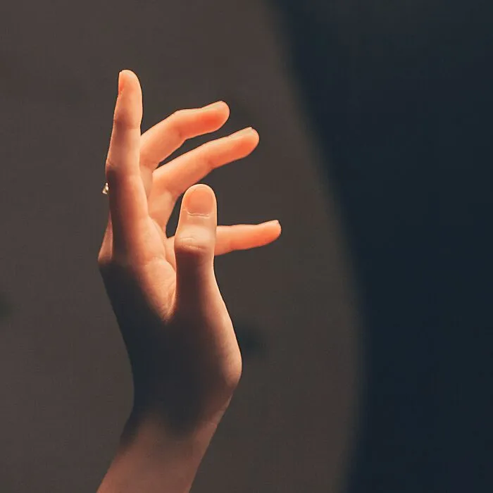 Close-up of a human hand with fingers slightly curled, illustrating one of the disturbing things about human bodies.