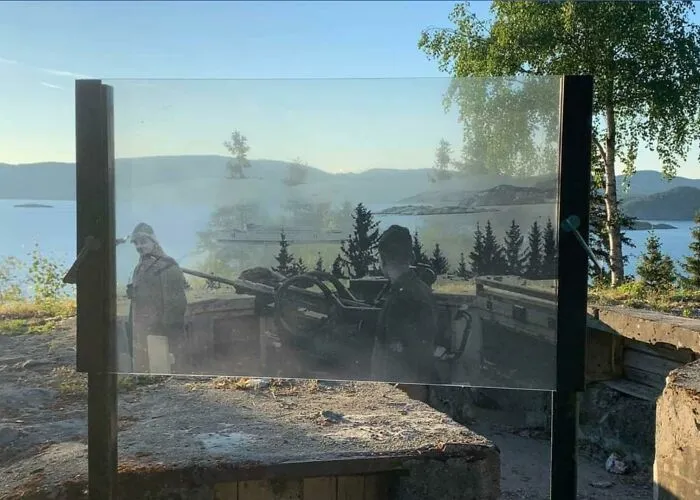 A German Aa Battery In Aasenfjord, Norway. A Transparent Screen With A Photo From The War Is Placed So You Can See What It Looked Like When New