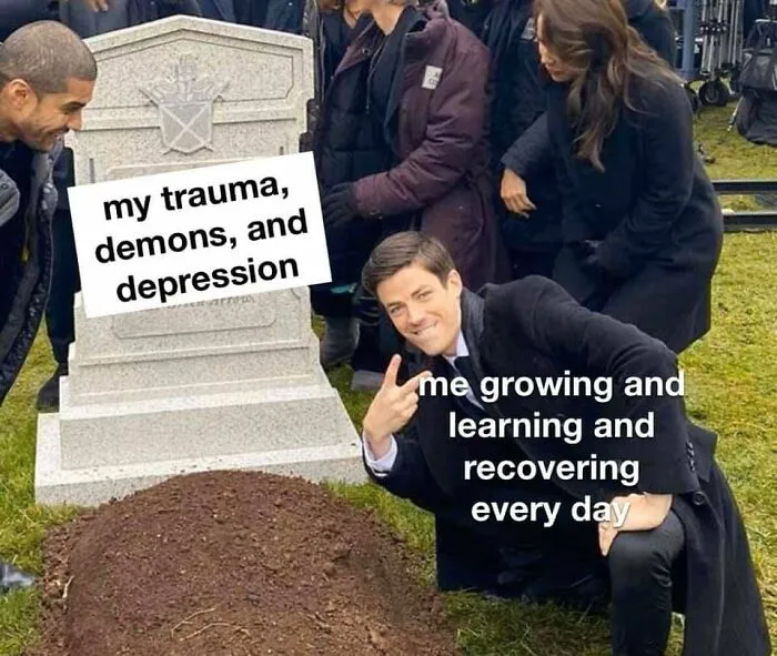 Man posing by a grave labeled with trauma, symbolizing recovery and wholesome growth.