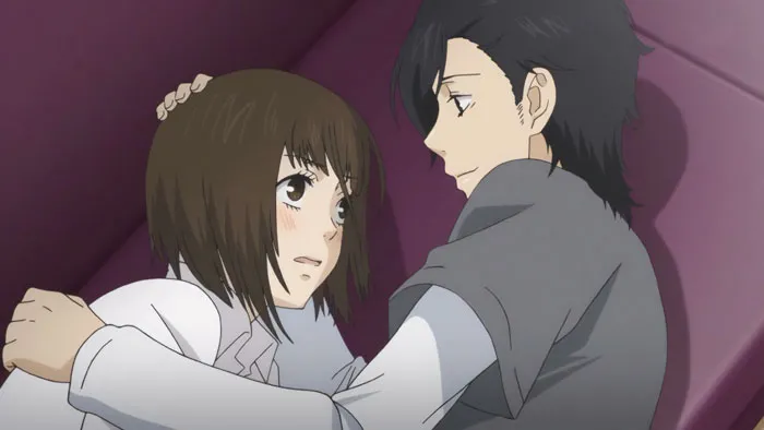 Anime couple embracing on a purple couch, showcasing one of the cutest moments.