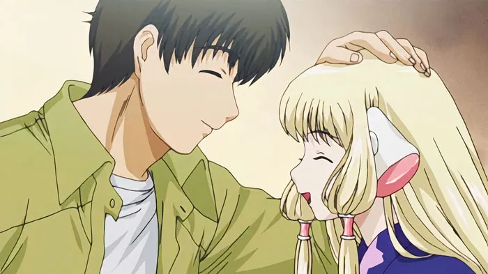 Anime couple sharing a tender moment, with one character gently patting the other's head, conveying cuteness.