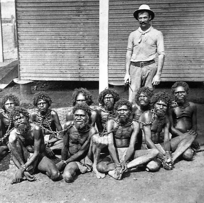 Photo Of A British Man Wearing A Chain Around The Neck Of Aborigines, Who Are Natives Of Australia. 1900's