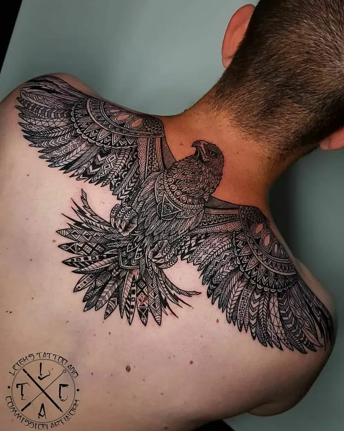 Intricate back tattoo of a detailed bird design, showcasing unique and crazy tattoo artistry.