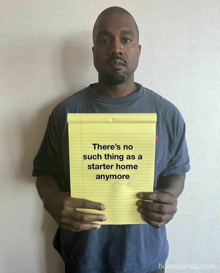 A person holding a notepad with the text "There's no such thing as a starter home anymore," reflecting homeownership memes.