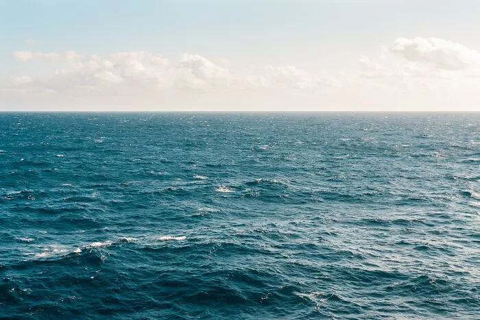 Vast ocean under a cloudy sky, illustrating some of the creepiest facts about the ocean’s mysterious depths.