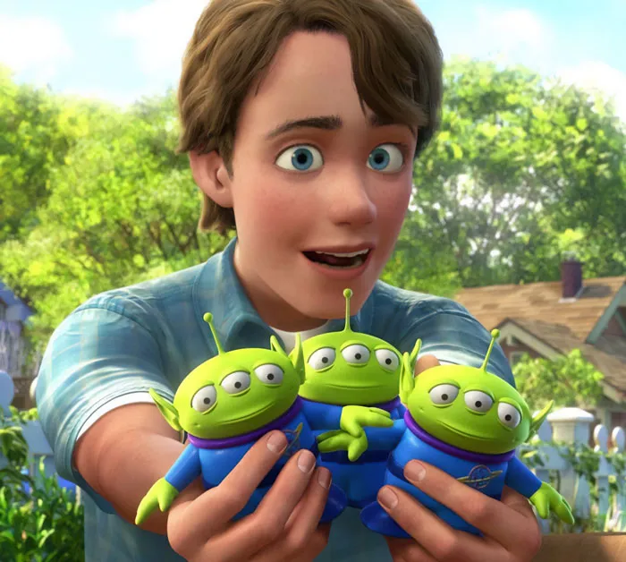 Andy holding aliens toys 