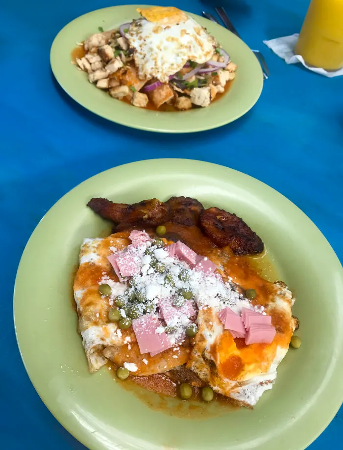 Huevos Motuleños (Front), And Chilaquiles With Fried Egg (Back)