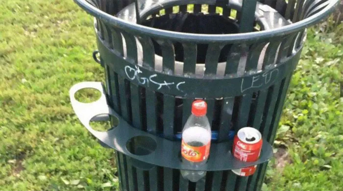 In Norway You Get A Small Amount Of Money For Recycling Bottles/Cans. They're Often Collected By Poor People, Homeless Etc. A Lot Of Our Trash Cans Has These Holders Around Them So People Don't Have To Search Through The Trash To Collect Them