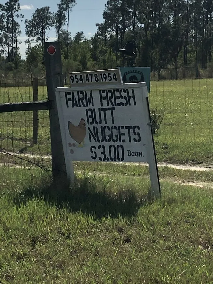 Sign advertising "Farm Fresh Butt Nuggets" at $3.00, showcasing a humorous alternative naming.
