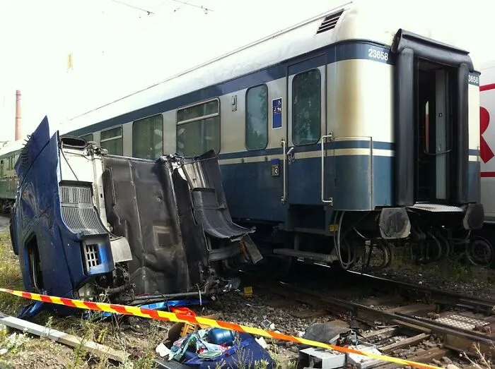 Train and overturned vehicle on tracks, illustrating bizarre yet true event.